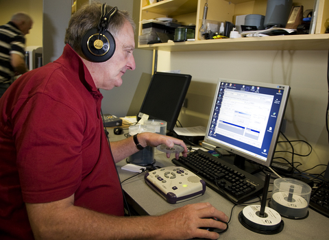 Man listening to Daisy book for quality checking in Duplicator Room