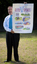 Maurice Gleeson holding a Blind Sports Victoria poster