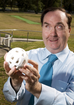 Maurice Gleeson holding an audible ball used in blind cricket