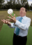 Maurice Gleeson tossing an audible ball used in blind cricket whilst standing next to a cricket pitch