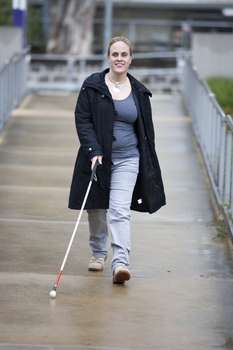 Penny Stevenson walking from Talbot Rd using a white cane