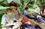 Sigrid and various children sit on a picnic blanket in a grassed area