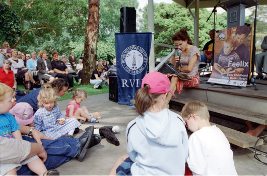 Families in front of a rotunda watching Sigrid Thornton read 'Owl Babies'