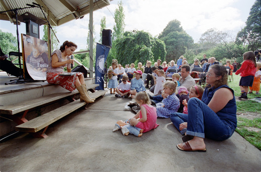 Families in front of a rotunda watching Sigrid Thornton read 'Owl Babies'