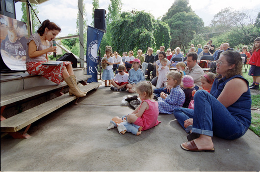 Families in front of a rotunda watching Sigrid Thornton read 'Owl Babies'