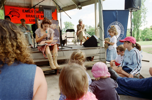 Families in front of a rotunda watching Sigrid Thornton read 'Owl Babies'