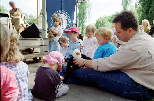 Families in front of a rotunda watching Sigrid Thornton read 'Owl Babies'