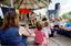 Families in front of a rotunda watching Sigrid Thornton read 'Owl Babies'