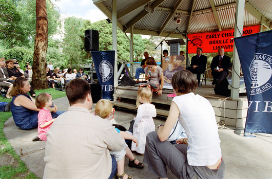 Families in front of a rotunda watching Sigrid Thornton read 'Owl Babies'