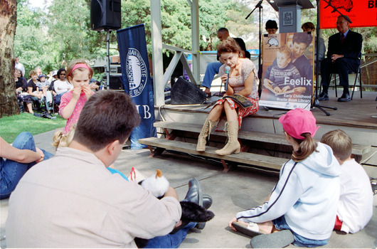 Families in front of a rotunda watching Sigrid Thornton read 'Owl Babies'