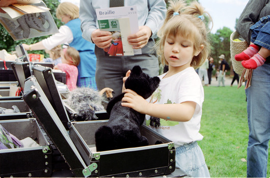 Children hold items from Feelix kits during the official launch at Melbourne Zoo
