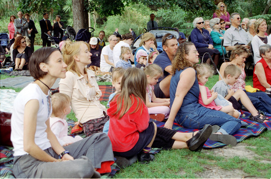 Families sitting on lawn watching official launch of Feelix in rotunda