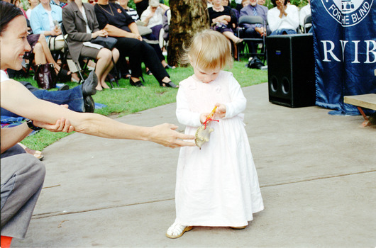 Children hold items from Feelix kits during the official launch at Melbourne Zoo