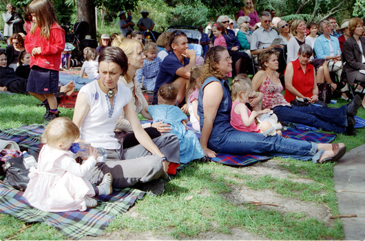 Families sitting on lawn watching official launch of Feelix in rotunda