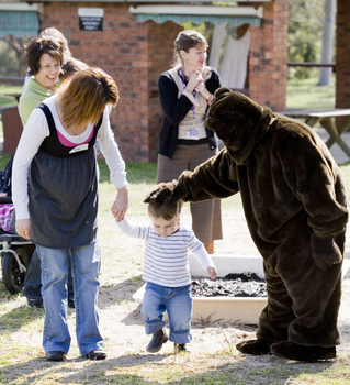 Bear (Ed Gamble) and the children on the Bear Hunt