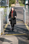 Renee crossing the train tracks at Kooyong station using her white cane