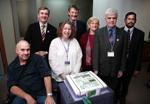 ?, Gerard Menses, Lynne Kells, Tim Evans, Roberta Ashby, Stephen Jolley and ? with 25th anniversary cake