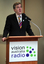 Gerard Menses at the podium for the 25th Anniversary of Vision Australia Radio