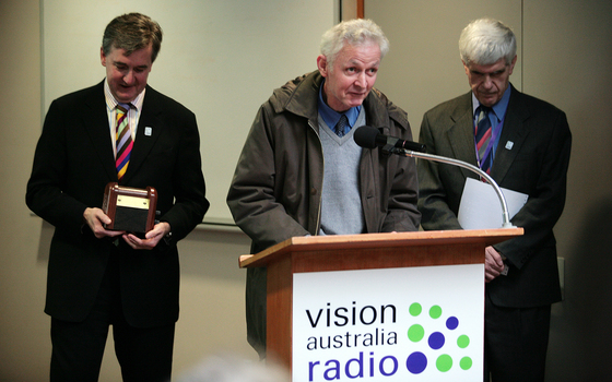 Gerard Menses, Norm Rees and Stephen Jolley at the podium for the 25th Anniversary of Vision Australia Radio