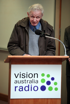 Norm Rees at the podium for the 25th Anniversary of Vision Australia Radio