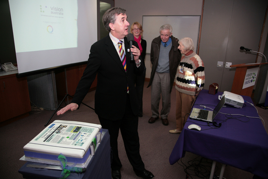 Gerard Menses and cake made for the 25th Anniversary of Vision Australia Radio