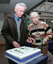 Norm Rees and Pam Adams with cake made for the 25th Anniversary of Vision Australia Radio