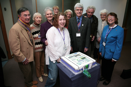 Pam Adams, Marj West, Lynne Kells, Roberta Ashby, Stephen Jolley, Norm Rees and others with cake made for the 25th Anniversary of Vision Australia Radio