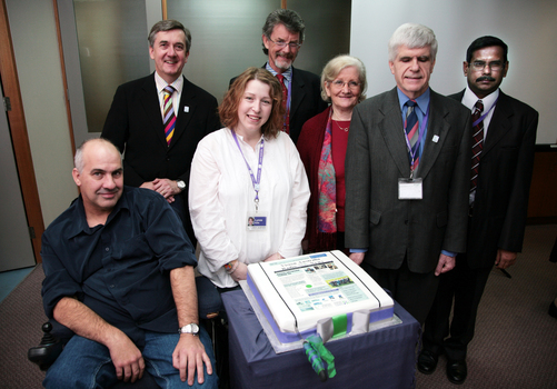 ?, Gerard Menses, Lynne Kells, Tim Evans, Roberta Ashby, Stephen Jolley and ? with 25th anniversary cake