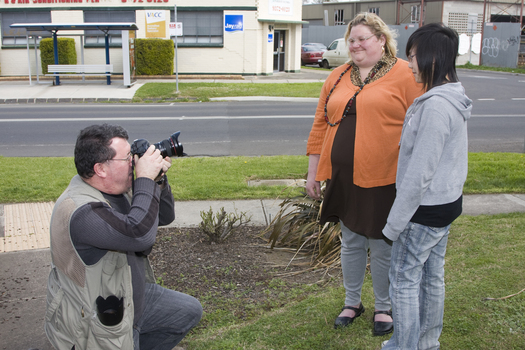 Photographer taking pictures of Jenny and Trudy outside Essendon office