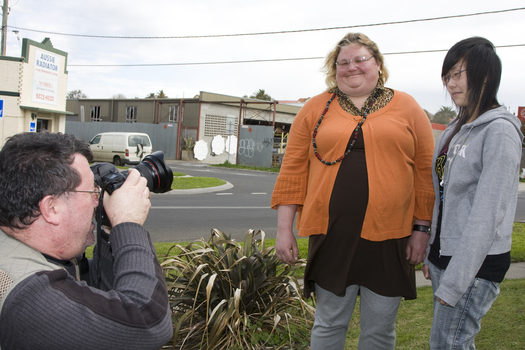 Photographer taking pictures of Jenny and Trudy outside Essendon office