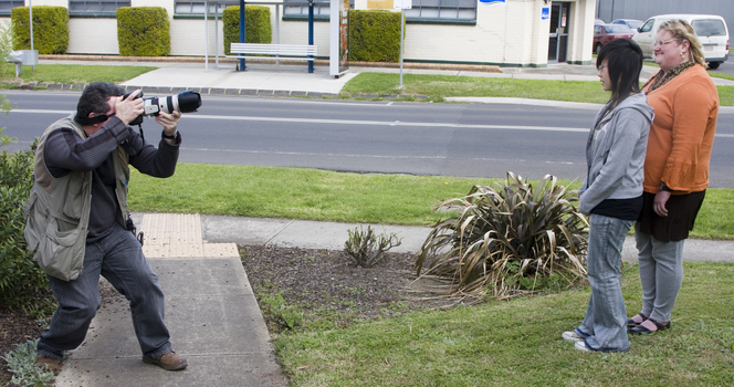 Photographer taking pictures of Jenny and Trudy outside Essendon office