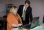 Trudy Ryall speaking with Bill Shorten as she demonstrates something on a computer