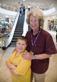 Mal Fraser and Richard Carbone stand in front of escalators