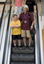 Mal Fraser and Richard Carbone on a descending escalator
