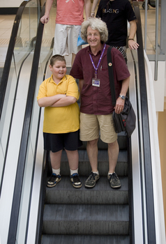 Mal Fraser and Richard Carbone on a descending escalator