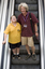 Mal Fraser and Richard Carbone on a descending escalator