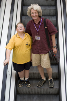 Mal Fraser and Richard Carbone on a descending escalator