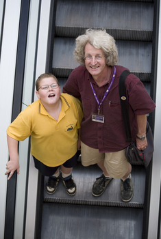 Mal Fraser and Richard Carbone on a descending escalator