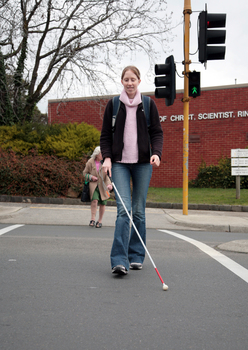 Anna crossing the road with her cane