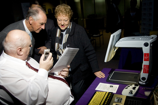 Jim Pipczak demonstrating a Nokia screen reader to John and Nancye Cain