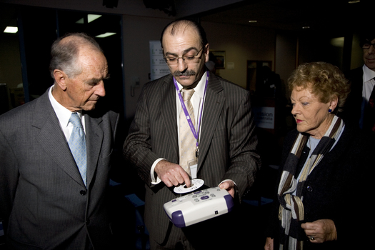 Tony Iezzi demonstrating a Daisy player and book to John and Nancye Cain