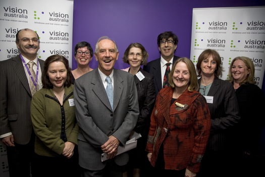 Nine people from the Victorian Library community face the camera