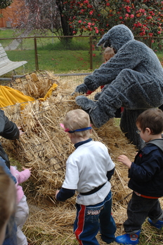 Children and the Big Bad Wolf (aka Ed Gamble) knock over the house of straw