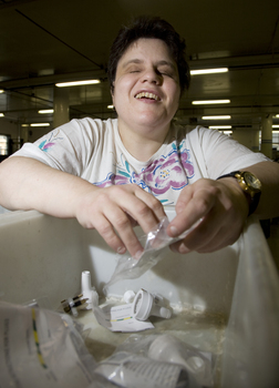 Woman packaging items at a bench