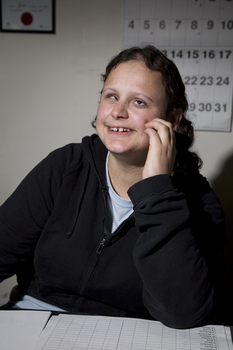 Gena Kacowicz looks to camera with a calendar in the background