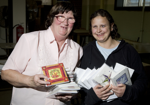 Mary Pipczak and Gena Kacowicz holding Christmas cards