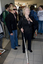 Female prepares to descend the escalator with her cane