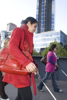 White cane users walking along river path at Southbank on a sunny day