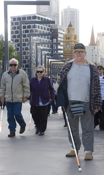 White cane users crossing bridge at Southbank on a sunny day