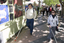White cane users walking along the St Kilda Road footpath on a sunny day